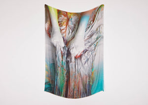 A limited edition artwork scarf by artist Katharina Grosse with a print of two hands clutching brightly coloured material.