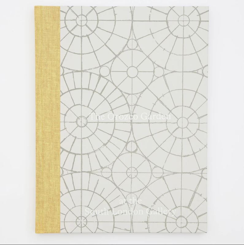 A grey and yellow book on a plain grey background. The book is titled 'The Orozco Garden' and explores Gabriel Orozco's garden made for the South London Gallery