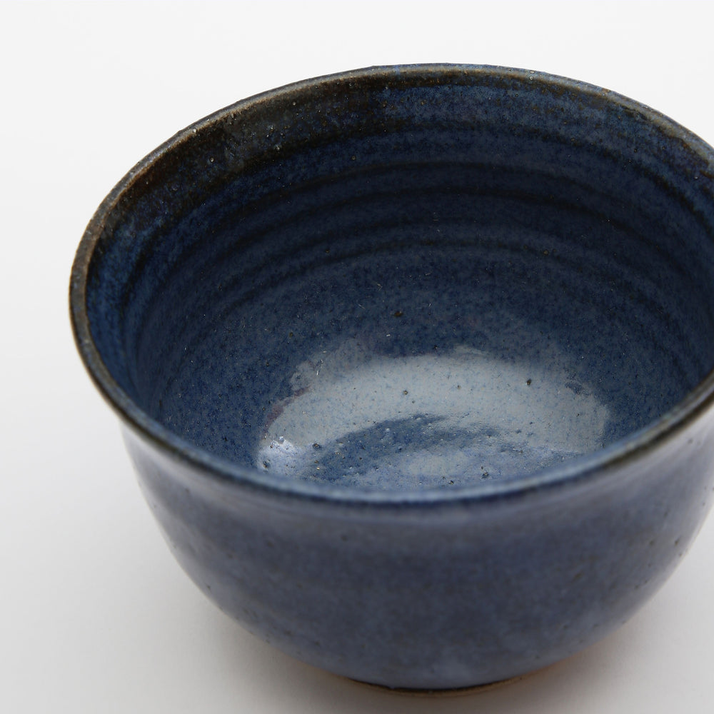 A small blue glazed ceramic bowl made by independent artist Alice King. Made in East Dulwich South London 