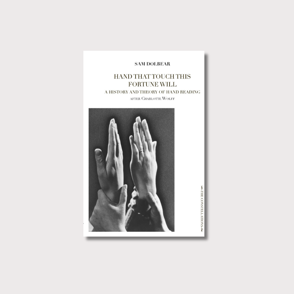 White book cover on light grey background with image of two hands