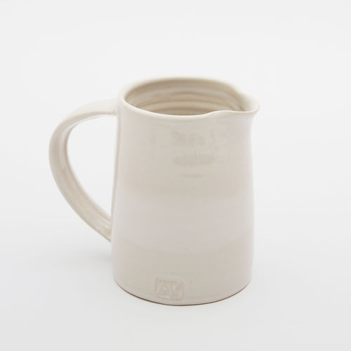 A large white jug with a handle and spout made by Alice King in south London, east Dulwich 