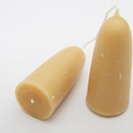 Two short yellow beeswax candles made by Moorlands
