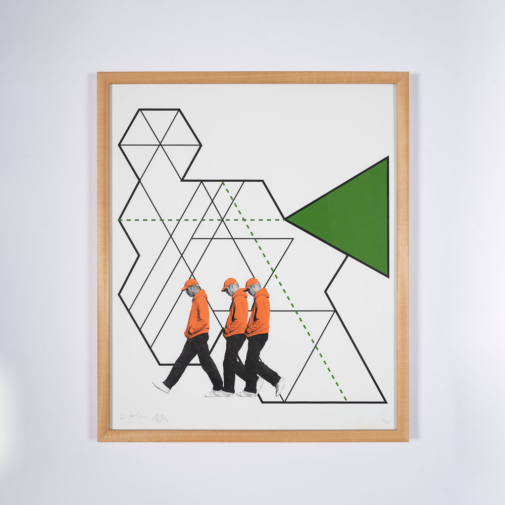 A framed collage print of various geometric shapes and a figure wearing a red hoody walking across the page.