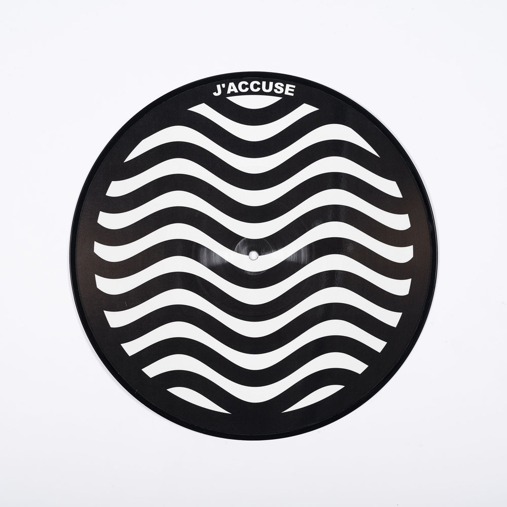 A vinyl disc with a wavy white and black pattern with the word 'J'accuse' on it.