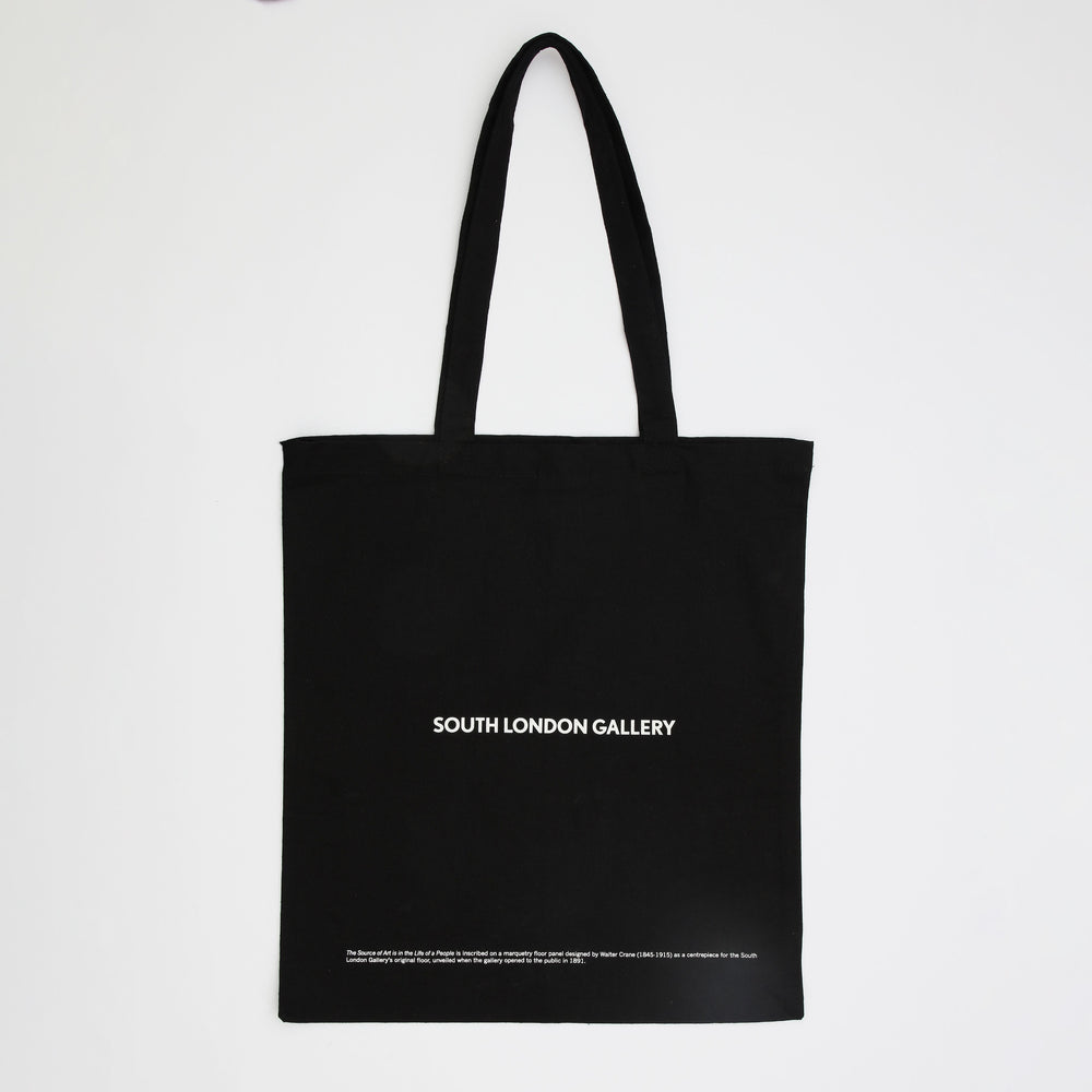 A black tote bag with white writing. The text says South London Gallery. 