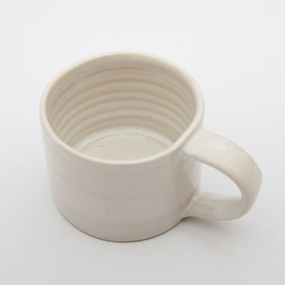A handmade ceramic white mug made by independent south London artist Alice King in east Dulwich