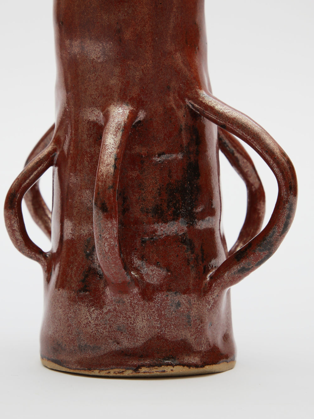 A tall skinny brown vase with handles made by independent artist Gwynnie Gaunt