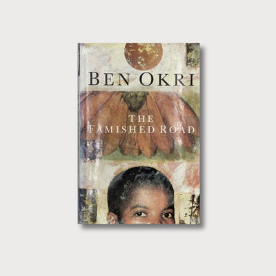 A book cover on a grey background. The cover appears to be a collage of painting and photographs, depicting flowers, fragments of trees, and the upper half of a young black boy's face. He is looking out from the page. The book is titled 'The Famished Road' and is written by Ben Okri.