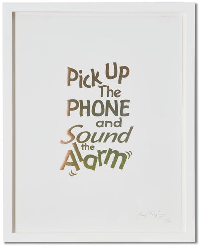 A framed print of a white page with metallic gold letters on it. This is a limited edition artwork by Rory Pilgrim. The text says Pick Up The Phone and Sound the alarm.
