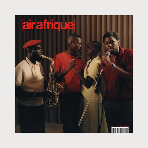 A magazine on a white background. The magazine is called Air Afrique. On the cover are four people, one person plays a saxophone beside two people dancing.