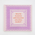 A square book with a purple pattern and orange writing. The book is titled Death Magick Abundance.